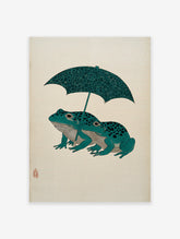 Japanese woodblock style art print of two teal frogs with black spots under a patterned dark green umbrella on a cream background.