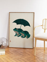 Japanese woodblock style art print of two teal frogs with black spots under a patterned dark green umbrella on a cream background. - Image 2
