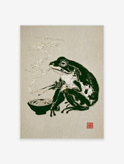 Illustrative Japanese frog art print of a dark green frog eating ramen noodles with chopsticks, with steam rising.
