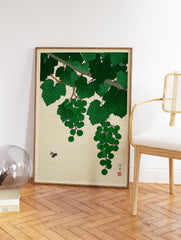 Japanese woodblock print of green grapes hanging from a vine with lush leaves and a bee hovering in a cream background. - Image 2