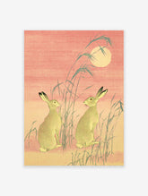 Japanese Hare Art print featuring two hares, moon, and reeds in traditional Ukiyo-e style with pink and green tones.
