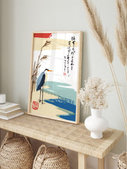 Japanese heron art print with reeds, blue water, and vertical calligraphy on a white, in an alternate framed mockup