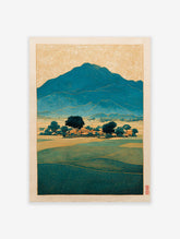 Japanese landscape art print showing teal mountains, green fields, and a village under a golden patterned sky in Ukiyo-e style.