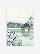 Japanese landscape wall art featuring a serene lakeside house, lush trees, and white botanical flowers in the foreground.
