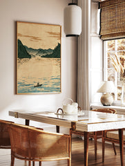 Illustrative Japanese-style landscape print showing a lone boatman on calm water with misty green, in a styled room mockup