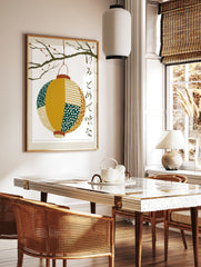 Japanese lantern wall art print with paper chōchin hanging from a berry branch and calligraphy on a, in a styled room mockup