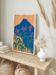 Japanese mountain wall art with a blue mountain, orange sky, and foreground of red-orange flowers and green leaves. - Image 3