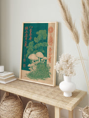 Japanese woodblock print of white mushrooms on moss with green leaves and red kanji on a dark, in an alternate framed mockup