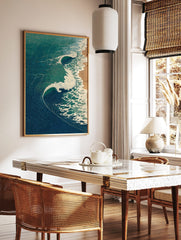 Japanese woodblock style art print of ocean waves with blue and teal water crashing onto a beige, in a styled room mockup