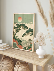 Japanese pagoda landscape print with pine trees, autumn foliage, and a soft sun in an, in an alternate framed mockup