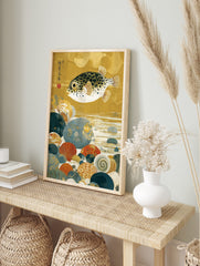 Japanese pufferfish art print with black spots, swimming over colourful seabed pebbles and, in an alternate framed mockup