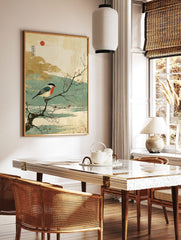 Japanese style print of a red-breasted bullfinch on a snowy branch with red berries and a red sun, in a styled room mockup