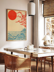 Japanese landscape print with red sun, flowering tree, blue waves, and a pagoda on a hill, in a styled room mockup
