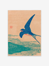 Japanese woodblock print of a blue swallow bird in flight over water against a peach background, vintage style.