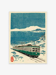 Japanese Train Wall Art woodblock print featuring a green train on tracks by a snowy blue sea and distant mountains.