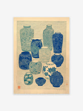 Collection of blue and teal Japanese vases with intricate patterns on a light background, vintage pottery wall art.