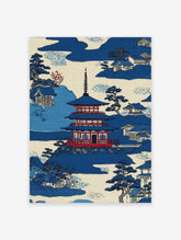 Japanese Wall Art print of a blue pagoda, traditional houses, and trees in a serene mountain landscape.