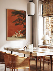 Japanese wall art print featuring two spotted deer resting under a dark pine tree against a vibrant red-orange background. - Image 2