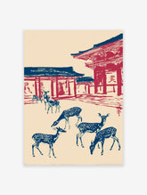 Japanese Wall Art print of blue deer with white spots in front of red and blue temple architecture on a cream background.
