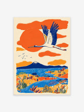 Japanese wall art print of a white crane flying over an orange and blue landscape with Mount Fuji, lake, and trees.