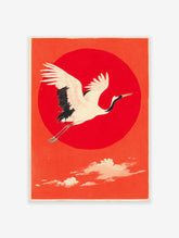 Traditional Japanese wall art print of a white and black flying crane against a large red sun and orange sky.