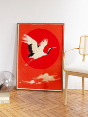 Traditional Japanese wall art print of a white and black flying crane against a large red sun and orange sky. - Image 2