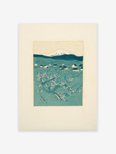 Japanese woodblock print of Mount Fuji, a village, and cherry blossoms in teal and white.