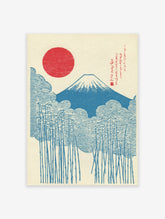 Japanese woodblock style print of Mount Fuji, a red rising sun, blue clouds, and bamboo stalks on a cream background.