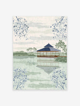 Japanese Wall Art featuring a serene pagoda on a lake with reflections, surrounded by green hills and blue botanical branches.