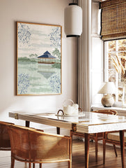 Japanese Wall Art featuring a serene pagoda on a lake with reflections, surrounded by green hills and blue botanical branches. - Image 2
