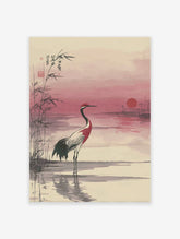 Japanese wall art print of a red-crowned crane in water with bamboo and a pink sunset.