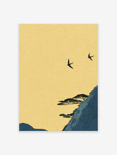 Japanese wall art print of two black swallows flying over a dark blue mountain with pine trees under a yellow sky.