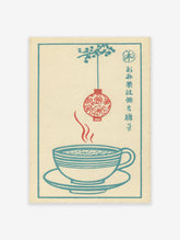 Vintage Japanese wall art print featuring a steaming blue tea cup, a red floral lantern, and blue foliage on a cream background.