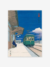 Japanese Wall Art print of a green tram at a station platform at night with a person sitting on a bench.
