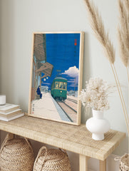 Japanese Wall Art print of a green tram at a station platform at night with a person sitting on a bench. - Image 3