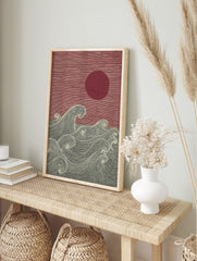 Japanese woodblock style art print with red sun and textured dark grey ocean waves, in an alternate framed mockup