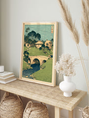 Traditional Japanese woodblock print showing a green landscape with houses, trees, a stone bridge over a blue river. - Image 3