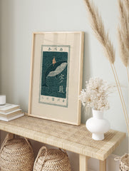 Japanese woodblock art print of a child riding a whale in dark teal and peach, with Japanese, in an alternate framed mockup