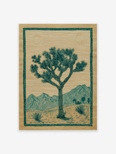 Joshua Tree poster depicting a desert landscape with mountains, two suns, and green botanical elements on brown paper.