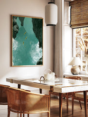 Aerial view of four yellow kayaks on a turquoise river canyon with dark rocky cliffs and white water, in a styled room mockup