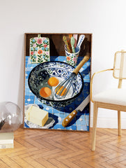Illustrative kitchen baking scene with eggs, whisk, butter, and floral cutting board on blue tiles, kitchen wall art. - Image 2