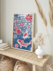Japanese woodblock style print of three red and white koi fish swimming with red lotus, in an alternate framed mockup