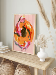 Painterly koi fish wall art print with three fish in a circular composition on a soft pink, in an alternate framed mockup