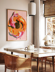 Painterly koi fish wall art print with three fish in a circular composition on a soft pink, in a styled room mockup