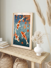 Japanese-style koi fish wall art print with orange carp and maple leaves in deep blue water, in an alternate framed mockup