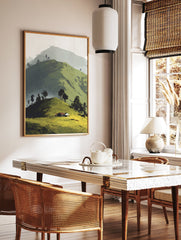 Illustrative landscape wall art of green rolling hills, scattered trees, and a small house with a red roof under a soft sky. - Image 2