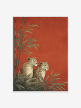 Two illustrative leopards sitting among green bamboo plants against a vibrant textured red background, an elegant Leopard Wall Art print.