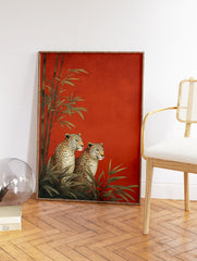 Two illustrative leopards sitting among green bamboo plants against a vibrant textured red background, an elegant Leopard Wall Art print. - Image 2