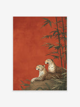 Two leopards lounging on a rock with bamboo stalks against a rich red-orange background in an illustrative leopard wall art print.