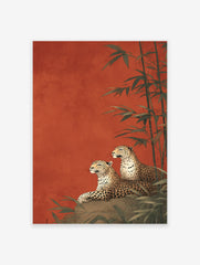 Two leopards lounging on a rock with bamboo stalks against a rich red-orange background in an illustrative leopard wall art print.